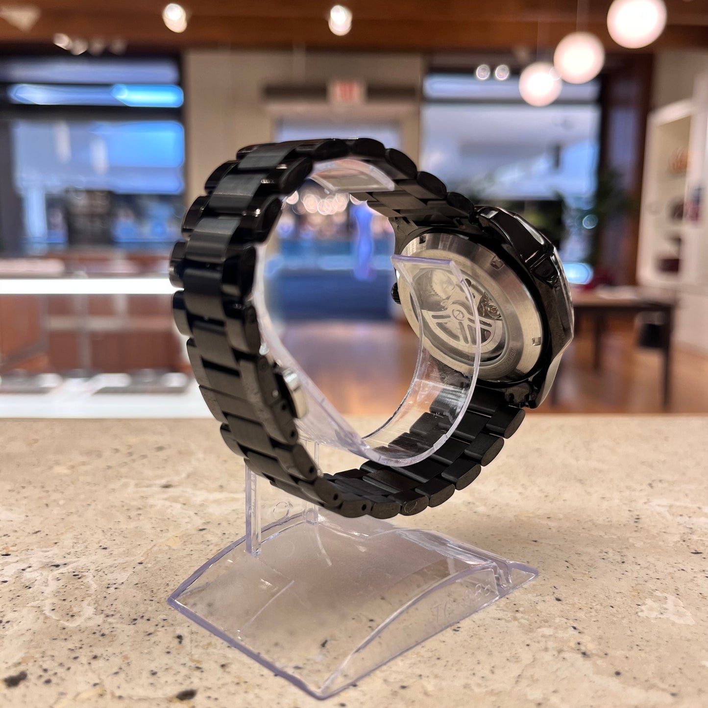 Black Mark Fairwhale Fairwind Automatic watch, side profile showing case and bracelet details, partially skeleton movement visible.