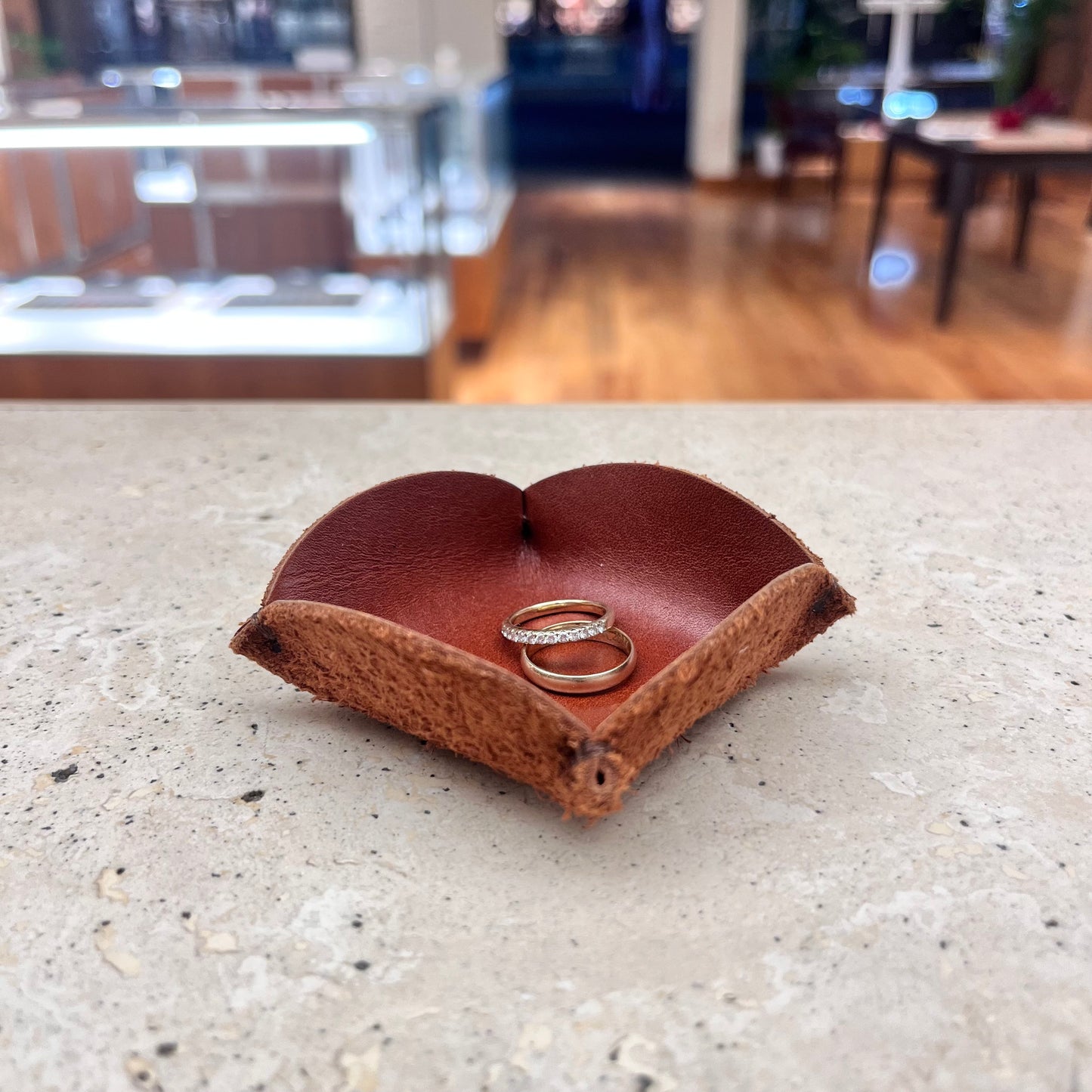 A sophisticated burgundy leather ring tray, ideal for showcasing your favorite jewelry pieces.