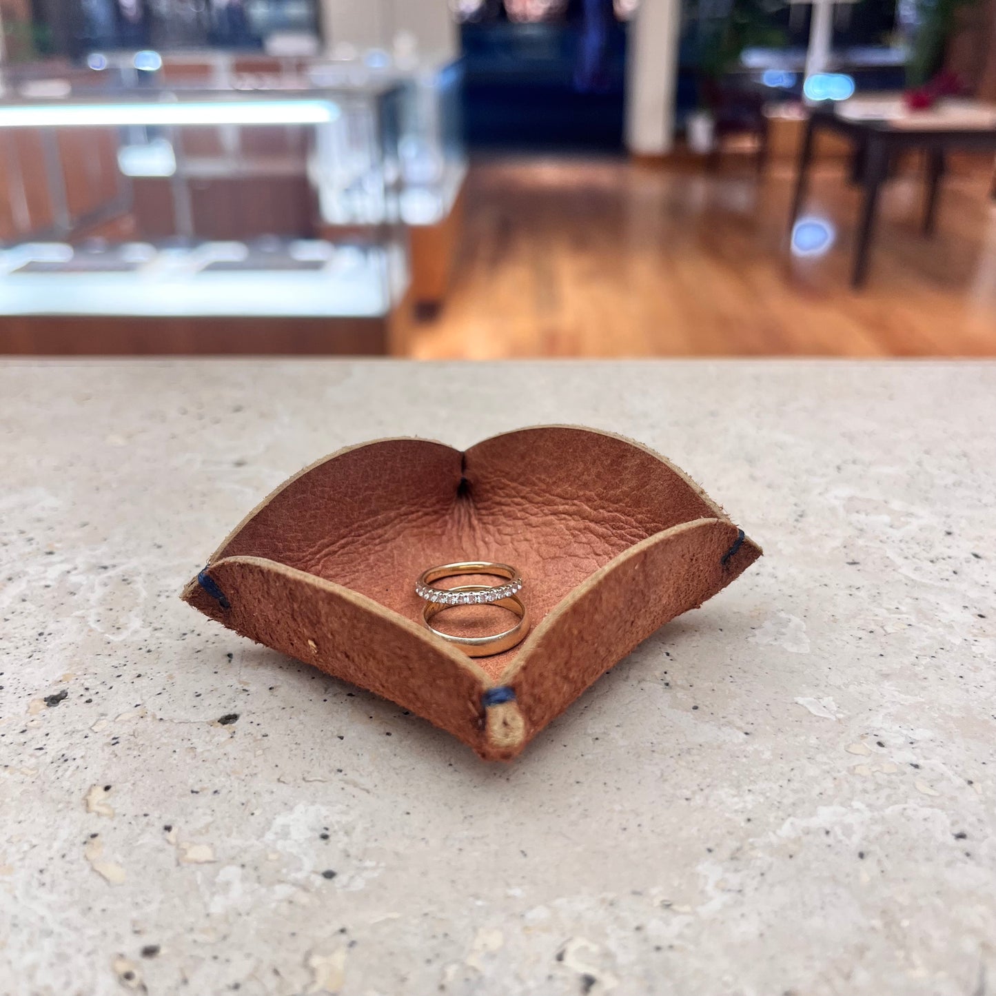 A versatile tan brown leather ring tray, perfect for adding a touch of warmth to your home décor.