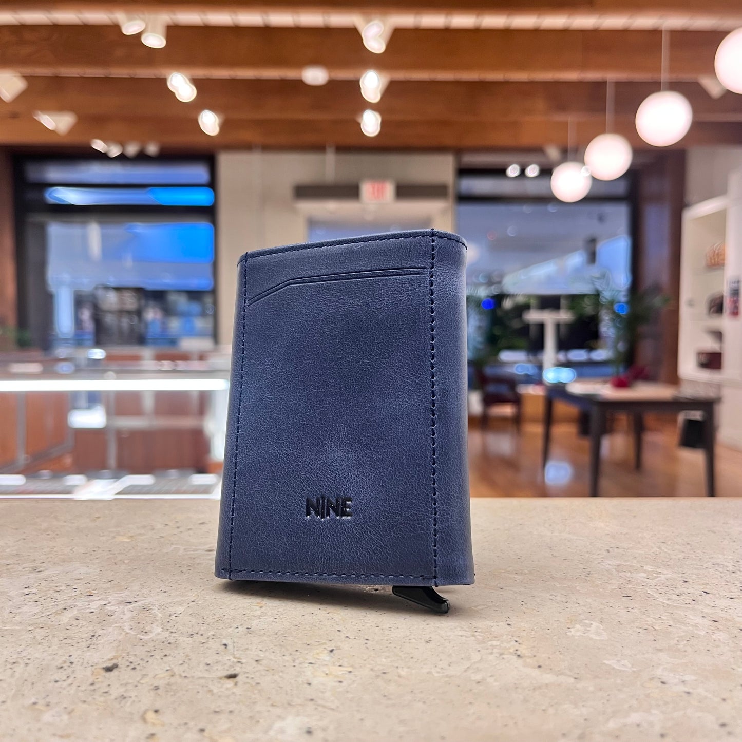 A stylish blue NINE Leather & Watch Mechanical Wallet, showcasing its modern appeal and refined aesthetic.