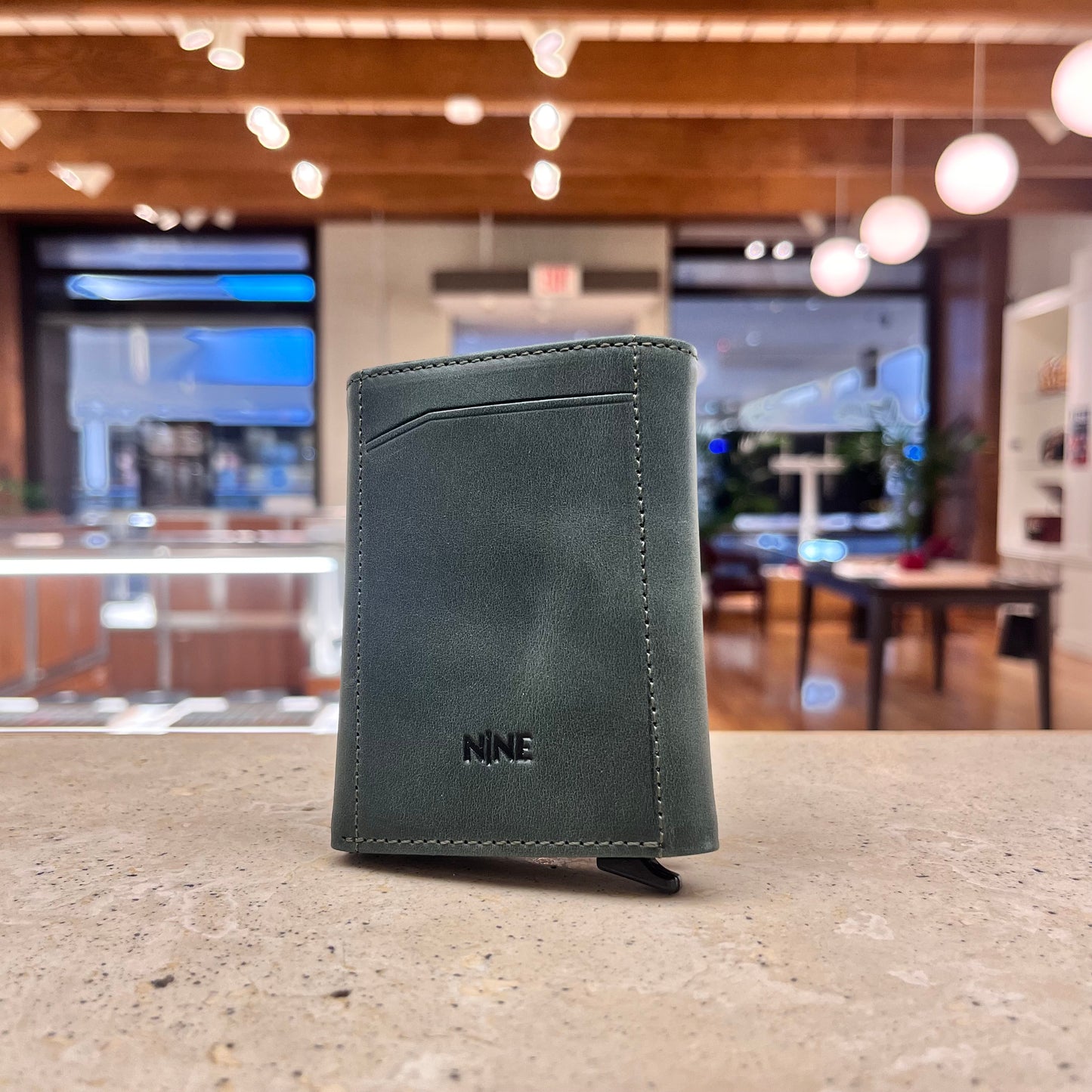 A unique green NINE Leather & Watch Mechanical Wallet, highlighting its distinctive color and contemporary style.