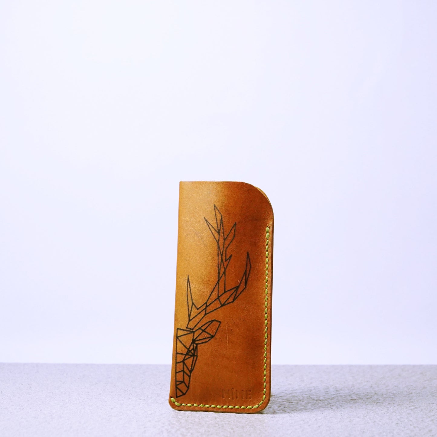 A personalized leather sunglasses case with laser engraved on the front, highlighting its custom touch.