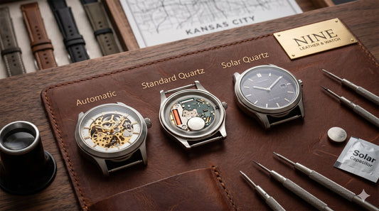 A comparison display at NINE Leather & Watch, showing an Automatic watch, an opened Quartz watch revealing its battery, and a Solar watch next to watchmaking tools and a replacement solar capacitor.