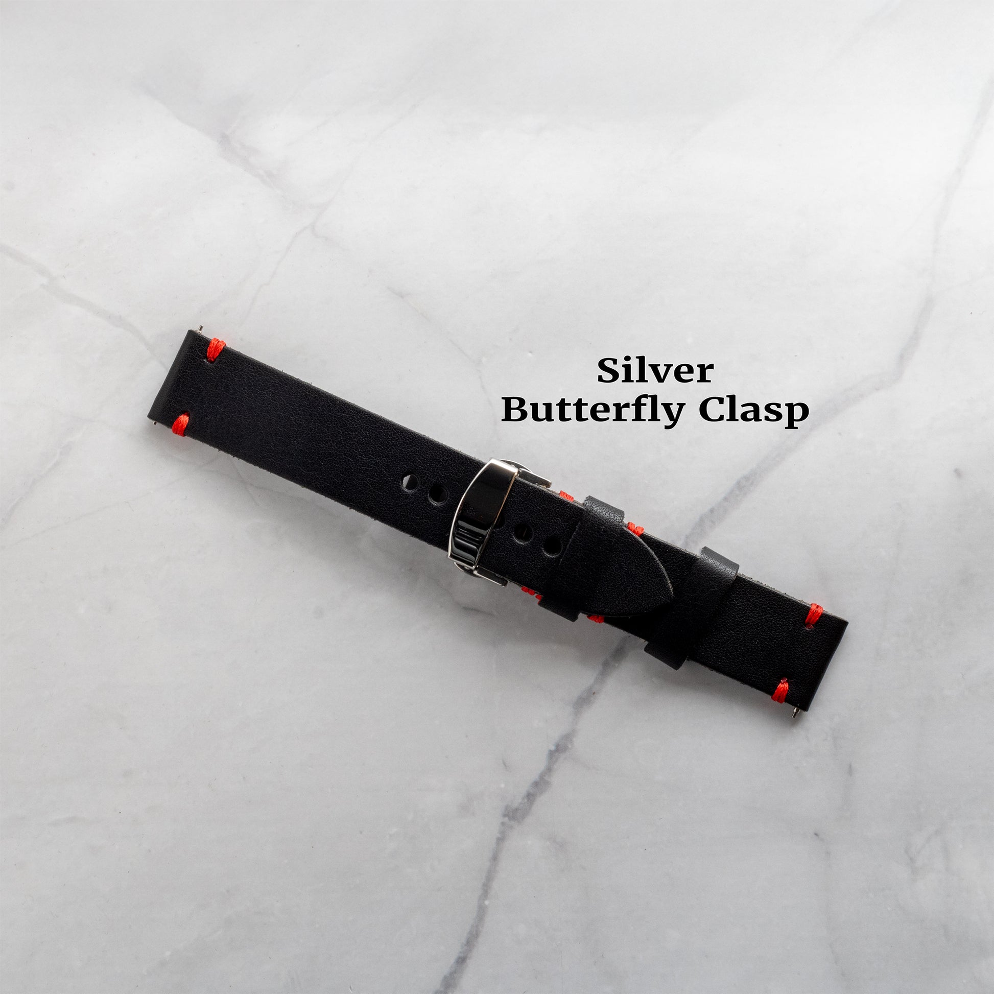 A black full-grain leather watch band featuring a sleek silver butterfly clasp upgrade for a secure, refined fit and easy wearability.