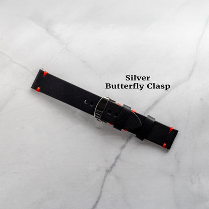 A black full-grain leather watch band featuring a sleek silver butterfly clasp upgrade for a secure, refined fit and easy wearability.