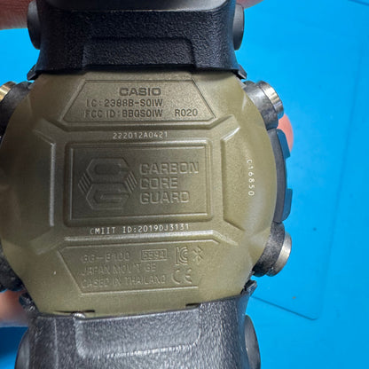 Close-up of the engraved case back of the Casio G-Shock GG-B100 watch, displaying the Carbon Core Guard logo, model number 5594, and structural details.