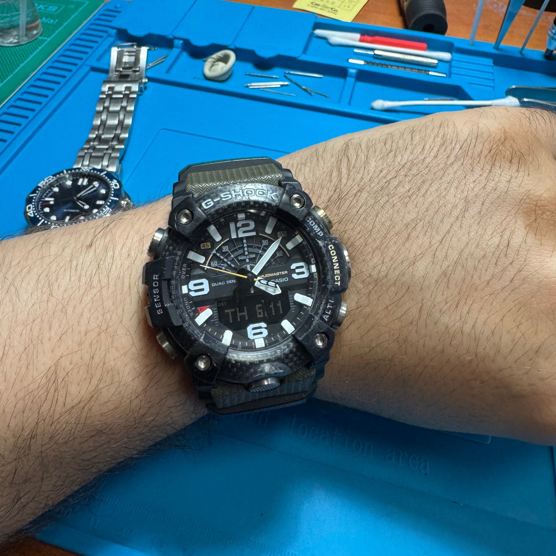 Front face of the restored tactical Casio G-Shock Mudmaster watch being worn on a wrist to demonstrate its size and fit.