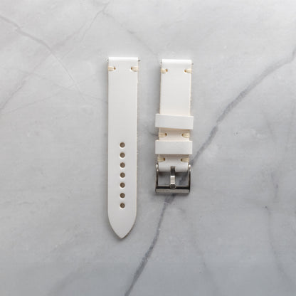 Meticulously fashioned white full-grain leather watch band with beige artisan hand-stitching, highlighting the supple texture and refined aesthetic of the material.