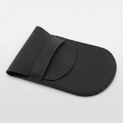 Minimalist black full-grain leather protective case for Apple Magic Mouse featuring hand-stitched edges and a secure leather strap closure on a white background.