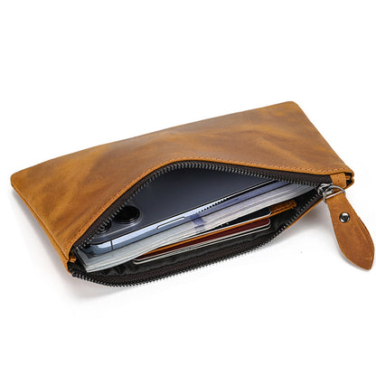 A tan brown Long Zipper Wallet open, revealing a phone, cards, and cash inside, showcasing its spacious design.