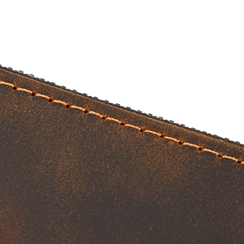 Extreme close-up of dark brown full-grain crazy horse leather, showcasing the natural texture and detailed stitching of the Long Zipper Wallet.