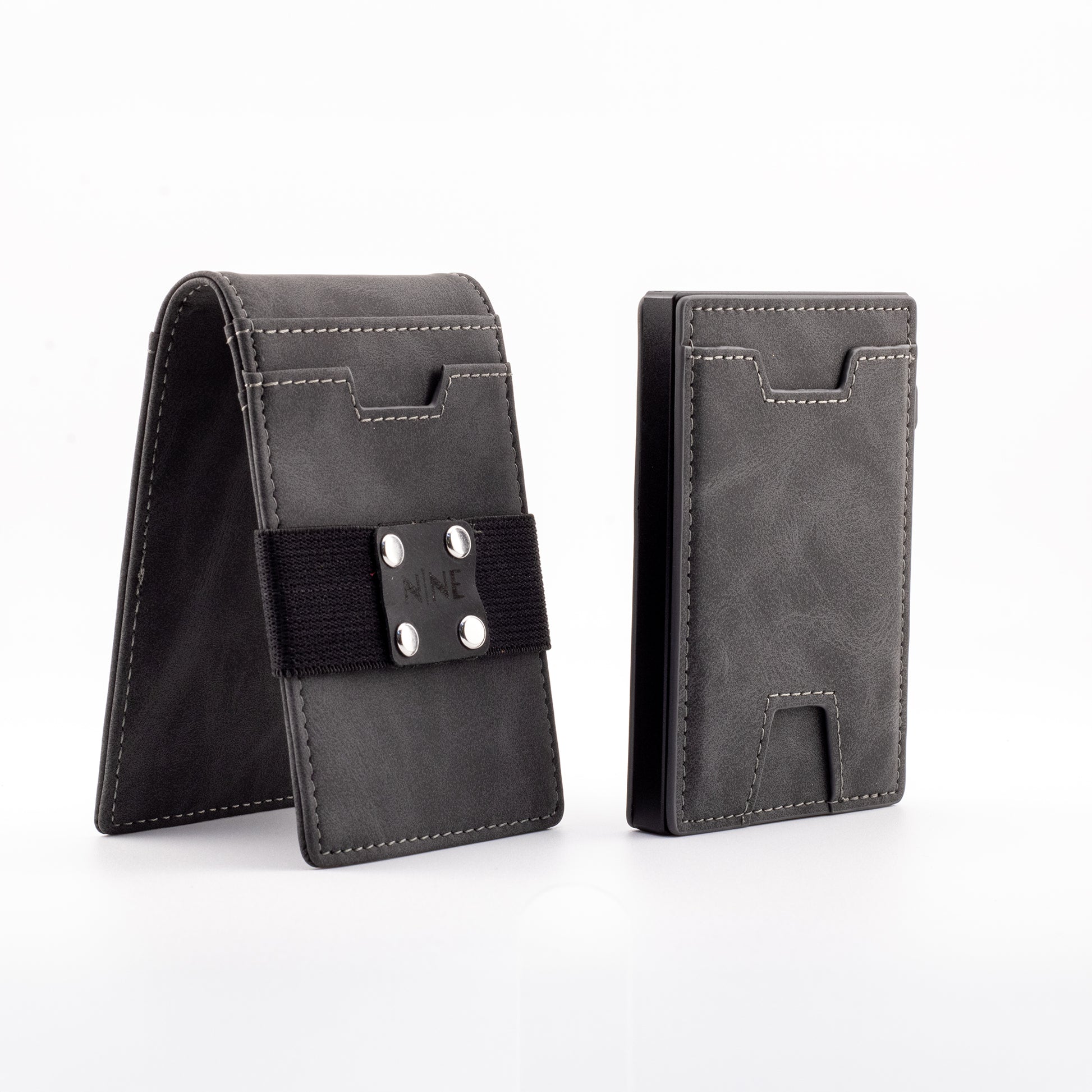 The NINE Leather Magnetic Pop-Up Wallet in gray genuine leather, showing the modular outer sleeve equipped with a black NINE branded money strap next to the slim RFID-blocking core.