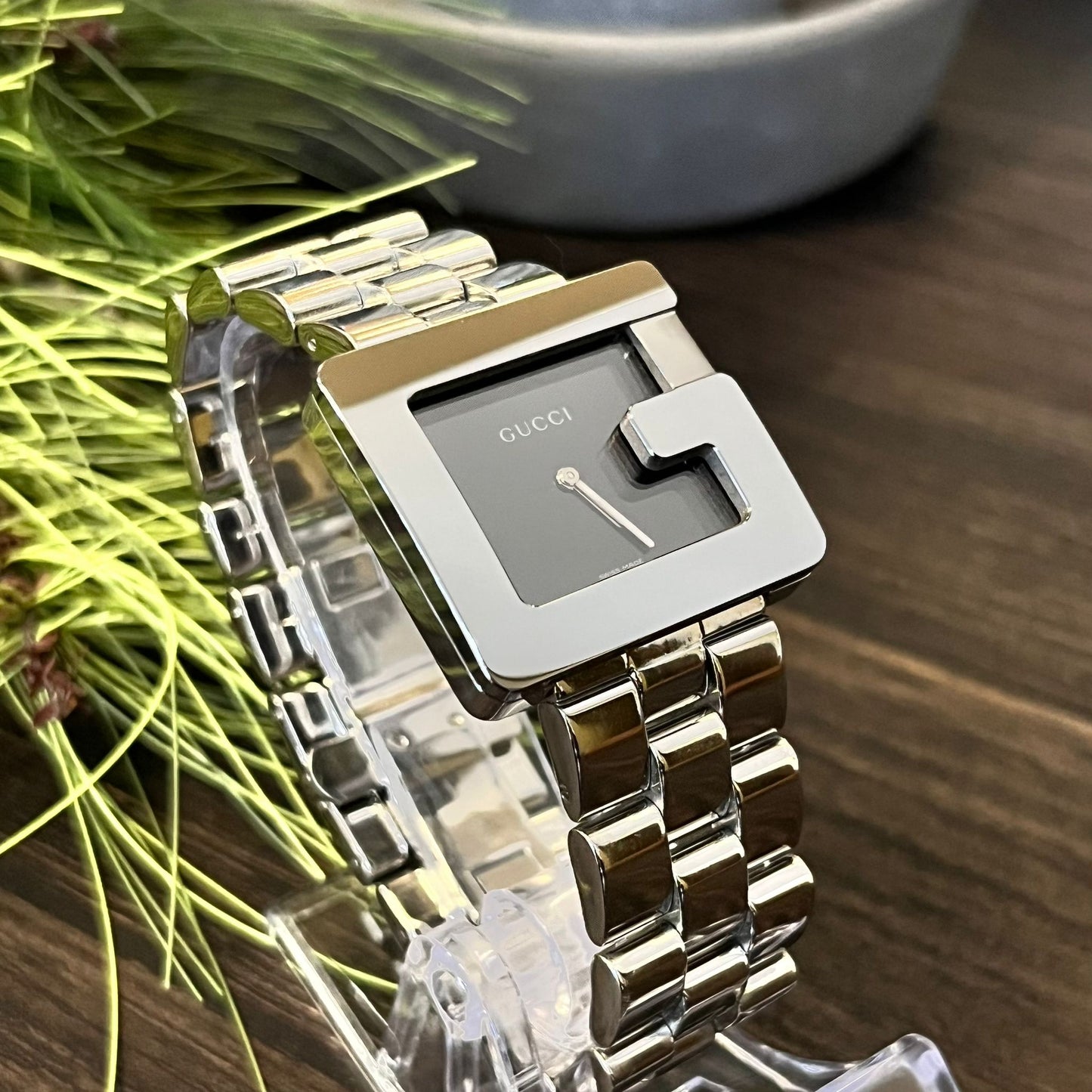 Restored vintage Gucci 3600M stainless steel watch with iconic G-shape case and black minimalist dial.