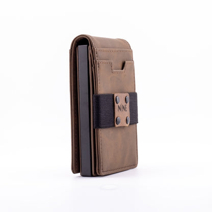 Side profile of the brown genuine leather magnetic wallet equipped with the modular upgrade sleeve, illustrating its ultra-slim footprint designed for everyday carry.