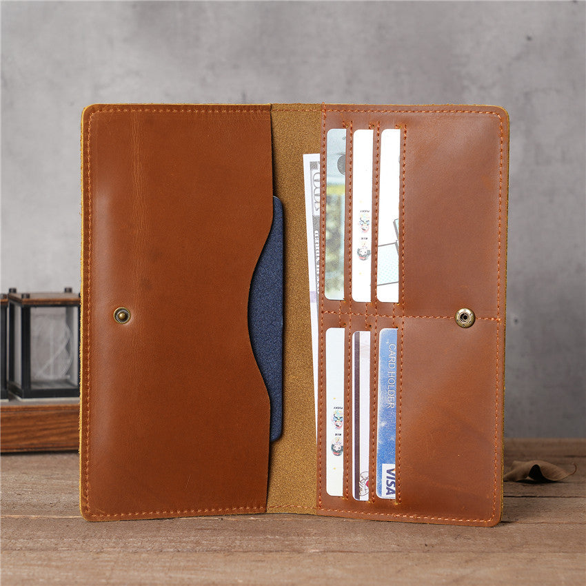 Tan brown handmade oil waxed leather Long Snap Wallet open, displaying card slots, cash compartment, and snap closure, with cards and a banknote visible inside.