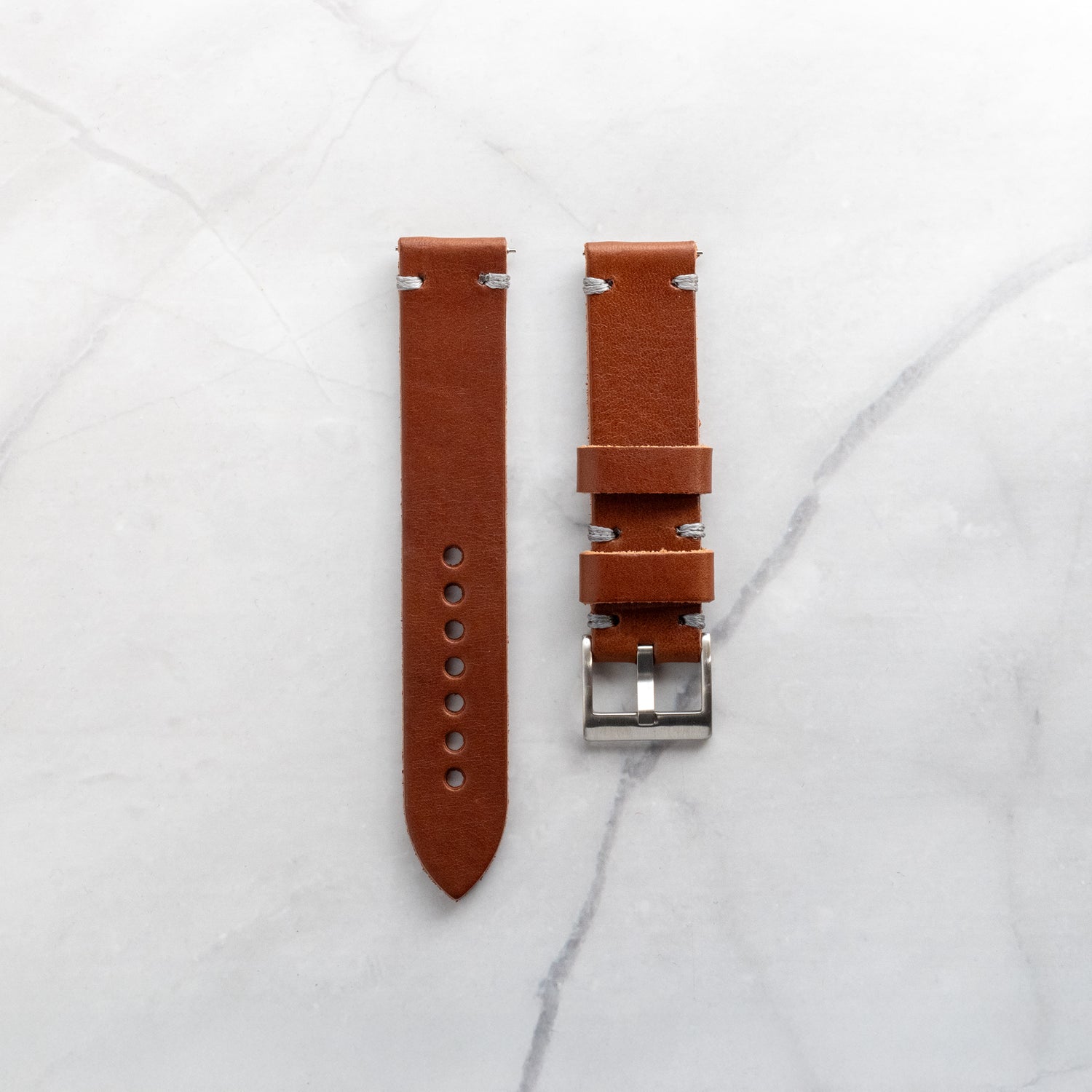 Supple tan leather watch strap with grey artisan stitching, showcasing the natural grain and character of premium handcrafted leather.