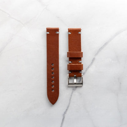 Supple tan leather watch strap with grey artisan stitching, showcasing the natural grain and character of premium handcrafted leather.
