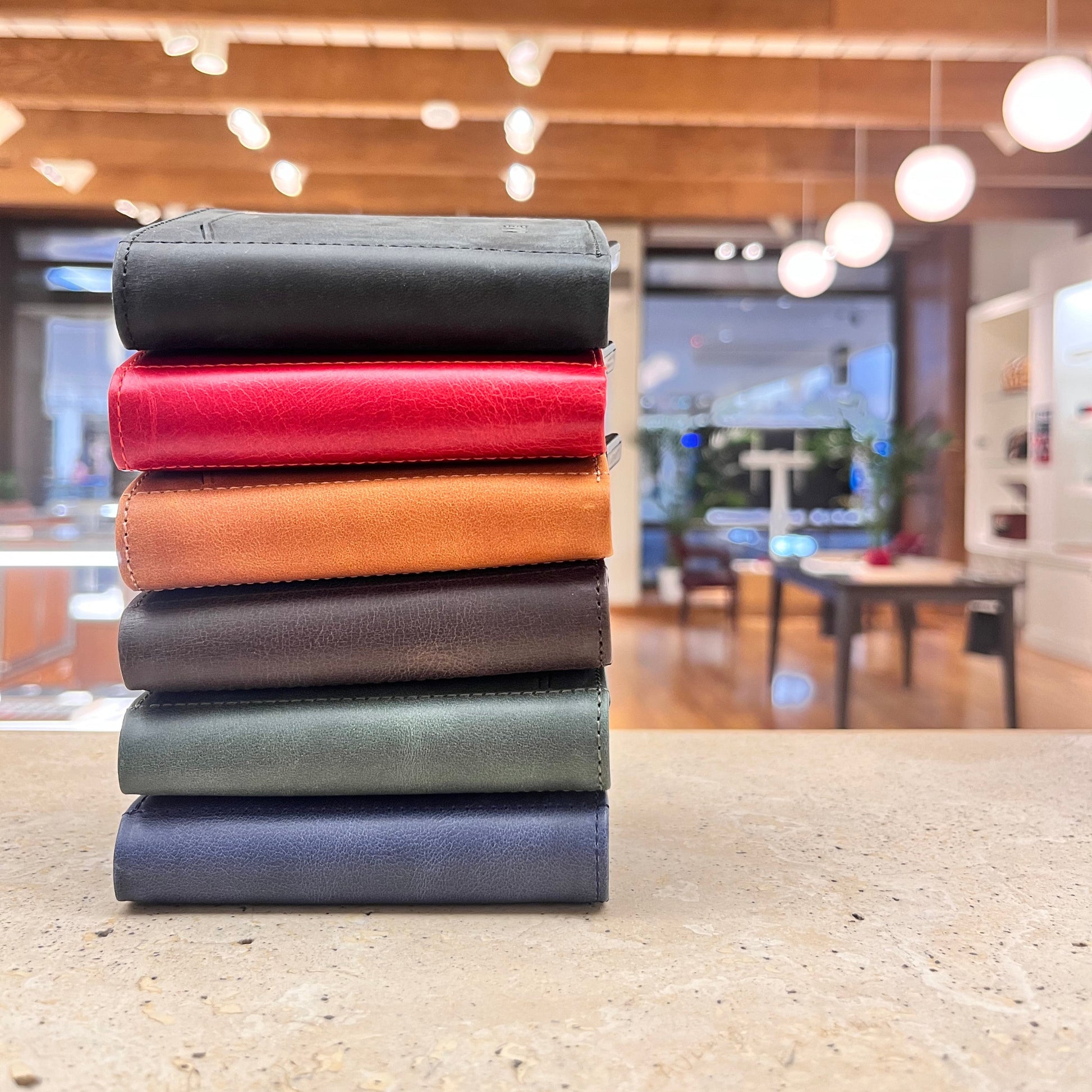 Stacked Nine Leather & Watch Mechanical Wallets in various colors, showcasing the range of options available.