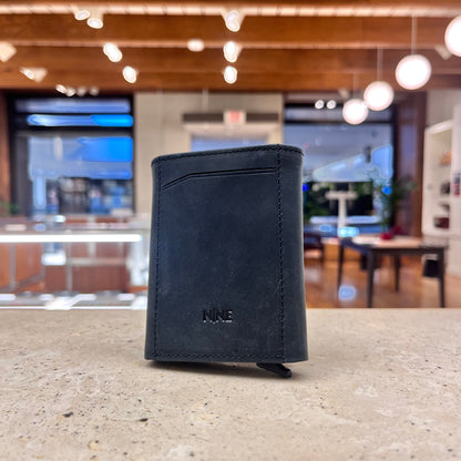 A sleek black NINE Leather & Watch Mechanical Wallet, showcasing its timeless elegance and versatility.