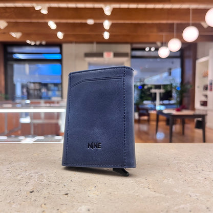A stylish blue NINE Leather & Watch Mechanical Wallet, showcasing its modern appeal and refined aesthetic.
