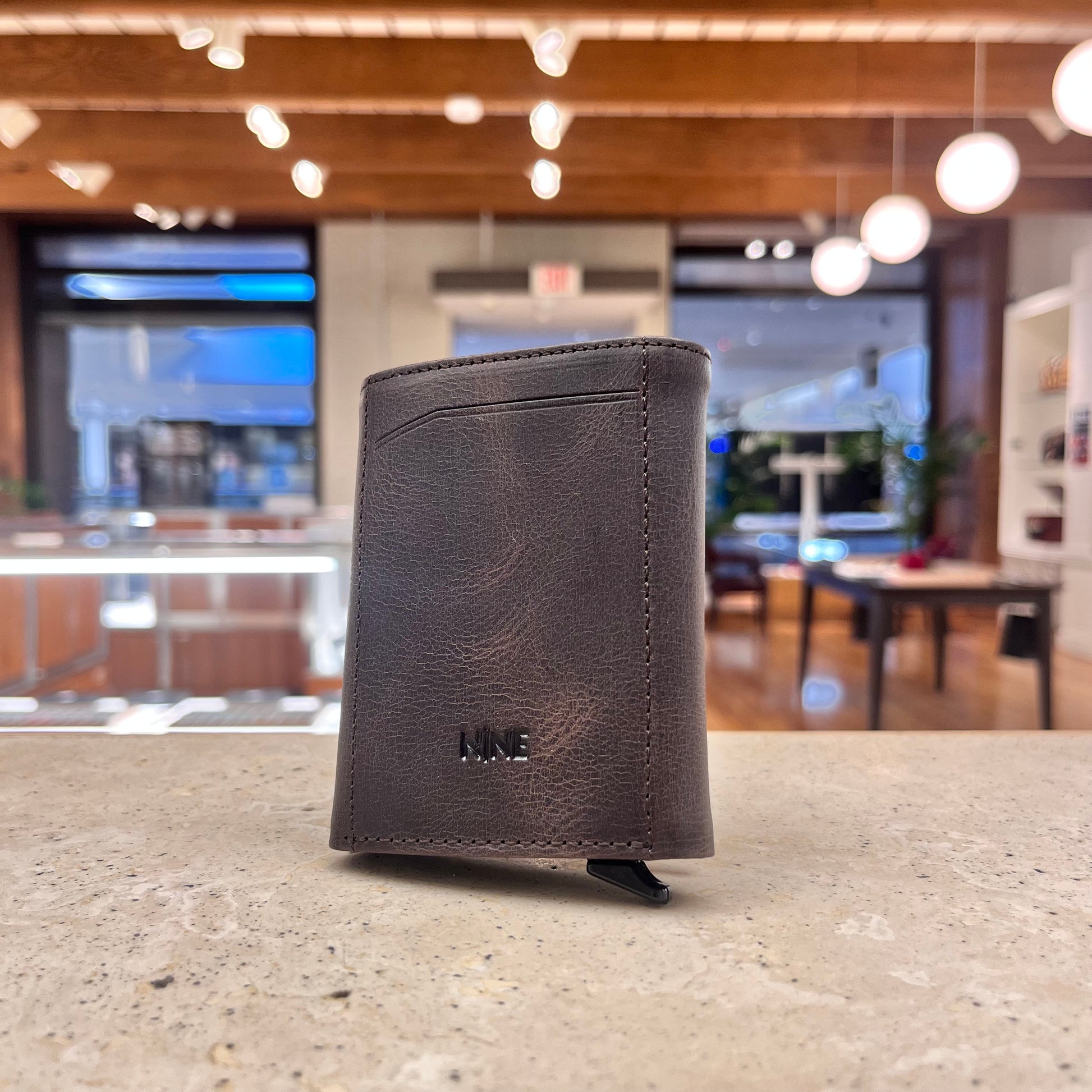 A brown NINE Leather & Watch Mechanical Wallet, highlighting its classic color and sophisticated appeal.