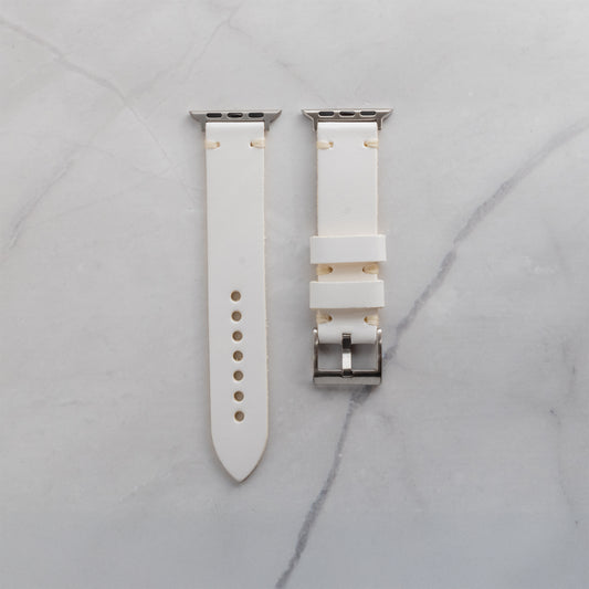 Premium white full-grain leather Apple Watch strap with cream-colored artisan stitching and silver-tone hardware for a refined, luxury look.