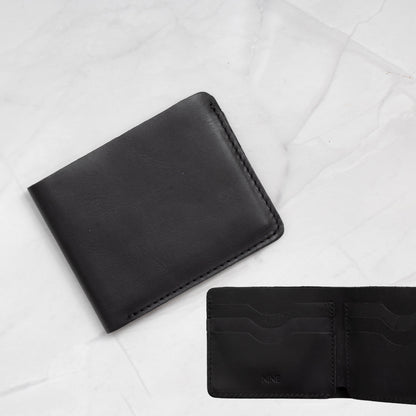 Black Full-Grain Leather Classic Bifold Wallet with a slim profile and 6 card slots.