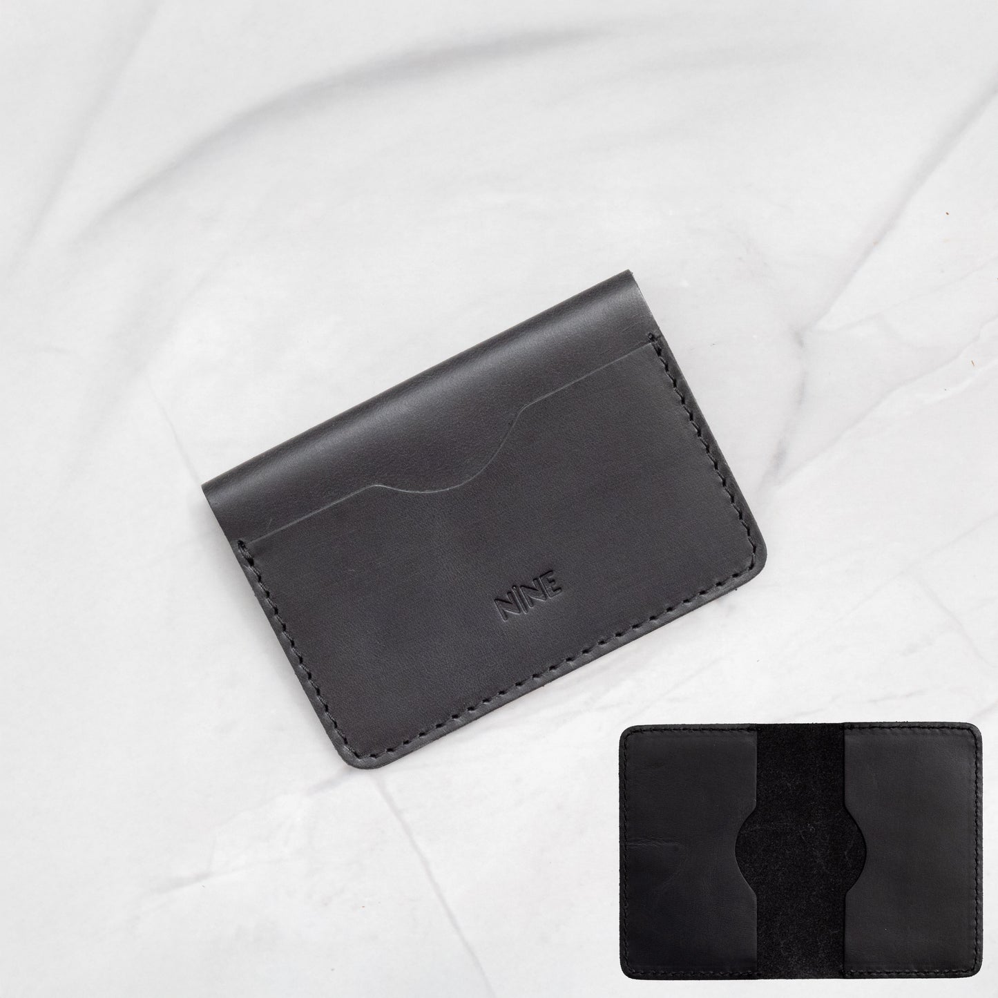 Black Full-Grain Leather Minimalist Bifold Wallet, emphasizing the slim card sleeve design.