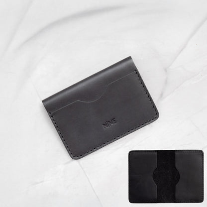 Black Full-Grain Leather Minimalist Bifold Wallet, emphasizing the slim card sleeve design.