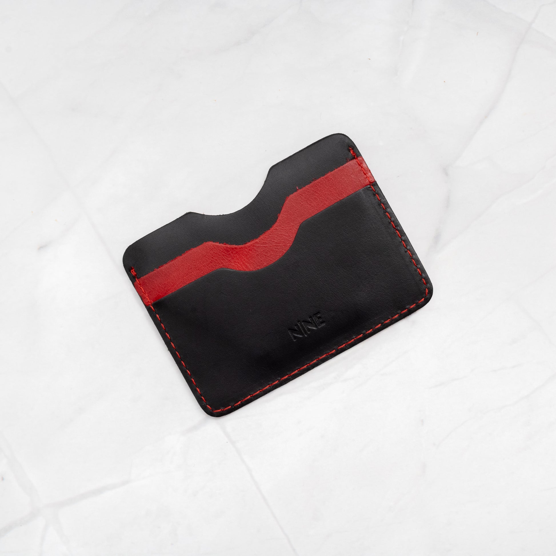 Black and Red two-tone Full-Grain Leather Compact Card Wallet interior, showing color contrast.