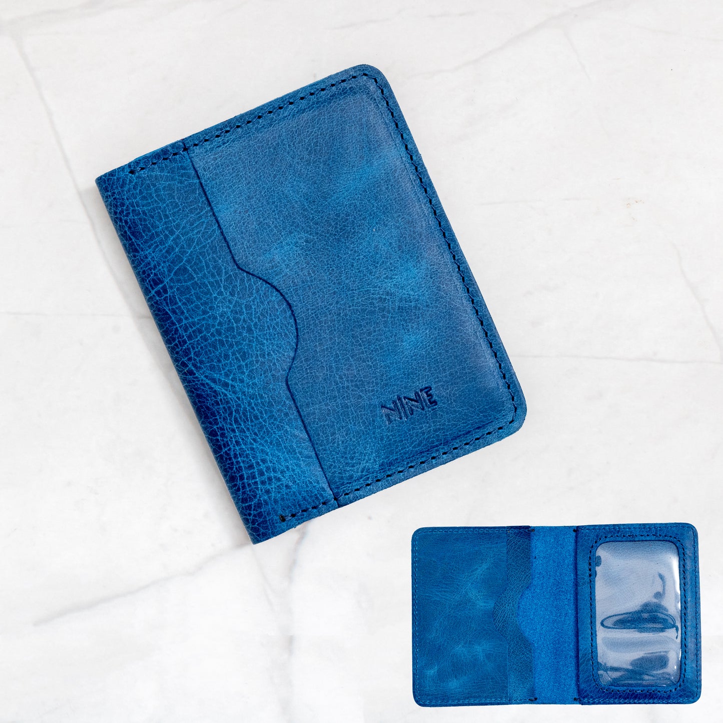 Blue Full-Grain Leather Bifold ID Wallet with black stitching and quick-view ID sleeve.