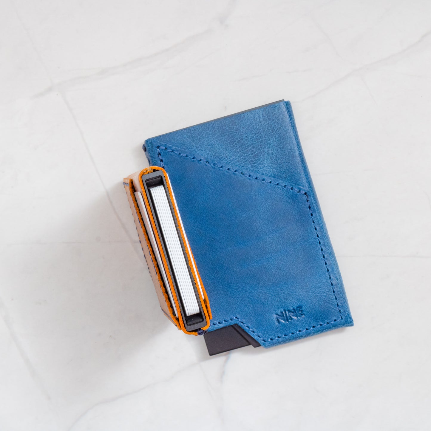 Blue and Tan NINE Pop-Up Wallets showing full-grain leather texture and slim profile