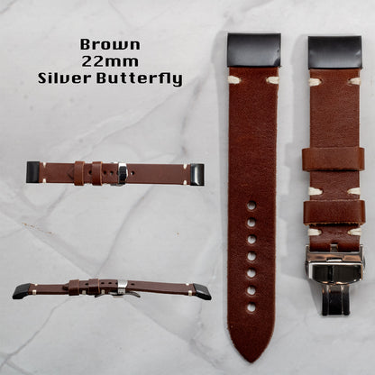 Brown full-grain leather Garmin replacement watch band, 22mm width, featuring white contrast stitching, black connectors, and a silver butterfly clasp. Displayed from multiple viewing angles.