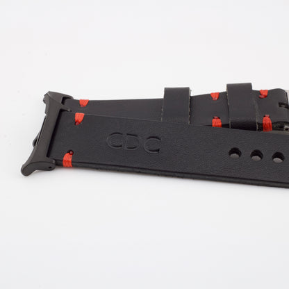 Close-up of a handcrafted black leather watch strap showing custom red stitching, a stamped CDC logo, and a matte black metal connector.