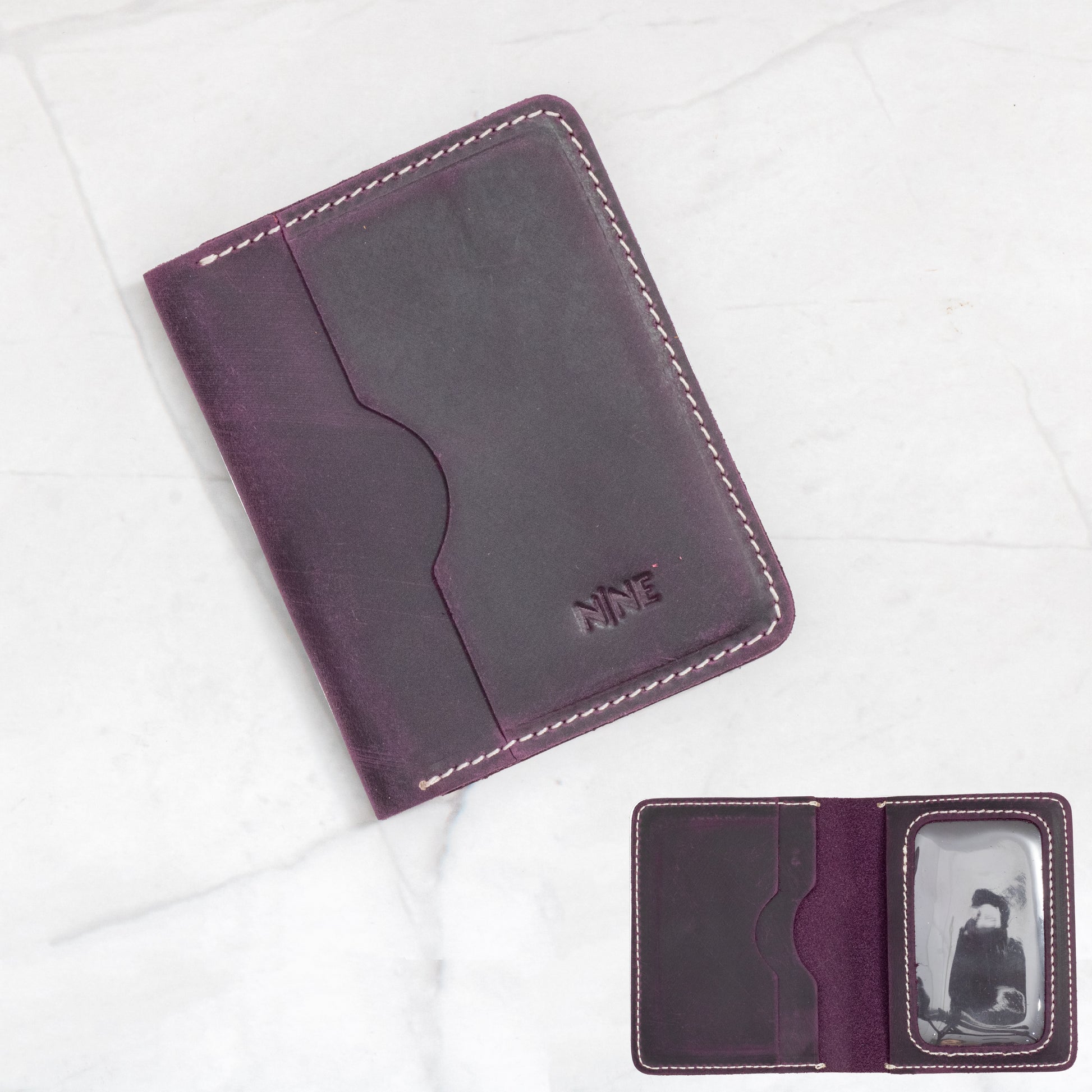 Purple Full-Grain Leather Bifold ID Wallet with white contrast stitching and interior quick-view ID sleeve.