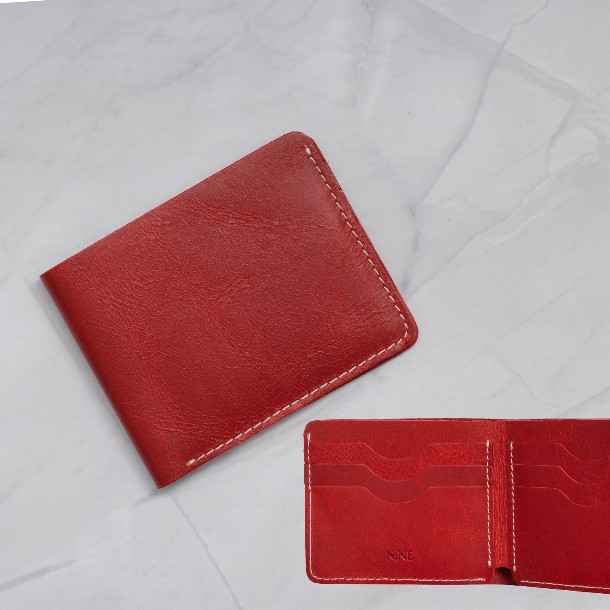 Red Full-Grain Leather Classic Bifold Wallet with a slim profile and 6 card slots.