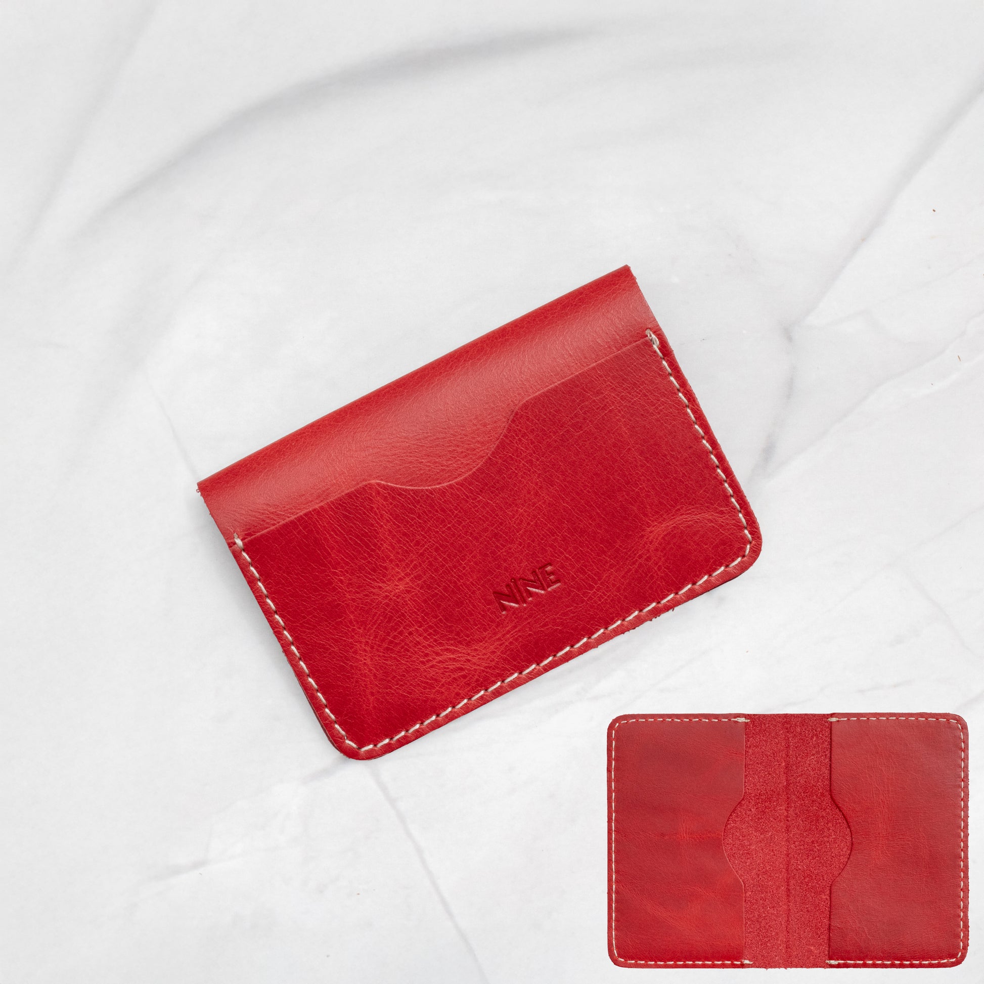 Red Full-Grain Leather Minimalist Bifold Card Wallet showing maximum capacity potential.
