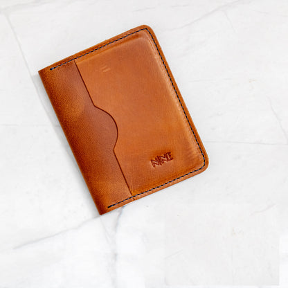 Tan Full-Grain Leather Bifold ID Wallet with blue stitching and interior quick-view ID sleeve.
