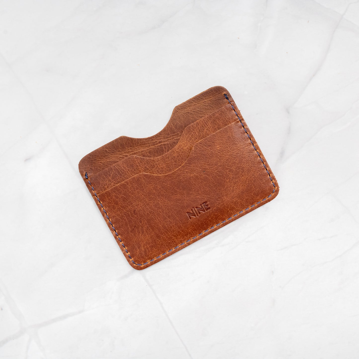 Tan Full-Grain Leather Compact Card Wallet, demonstrating the small size and durable quality.
