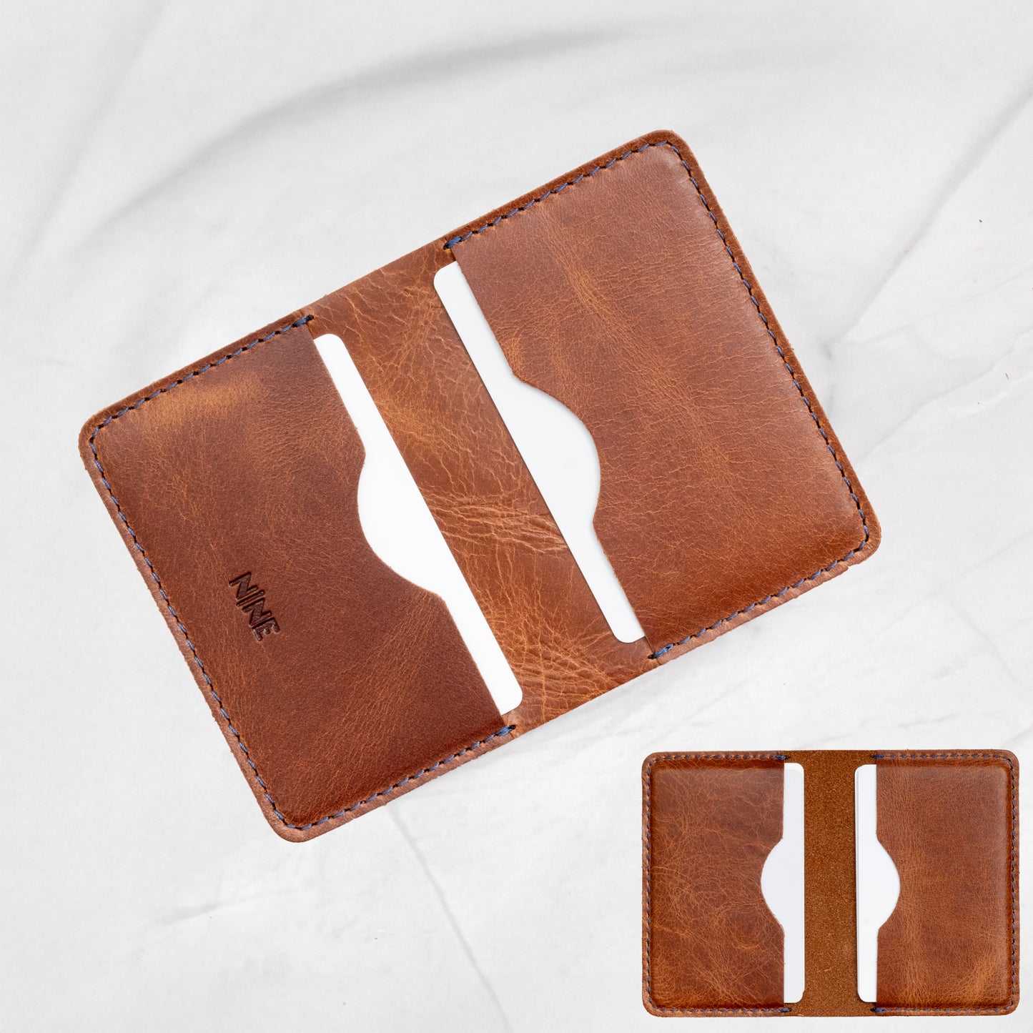 Tan Full-Grain Leather Minimalist Bifold Wallet with blue stitching, designed for essential cards.
