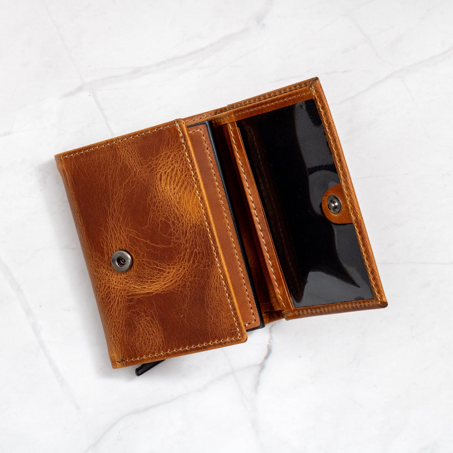 Interior view of the Tan Pop-Up Trifold Wallet with the snap closure and dedicated card/billfold pocket open.