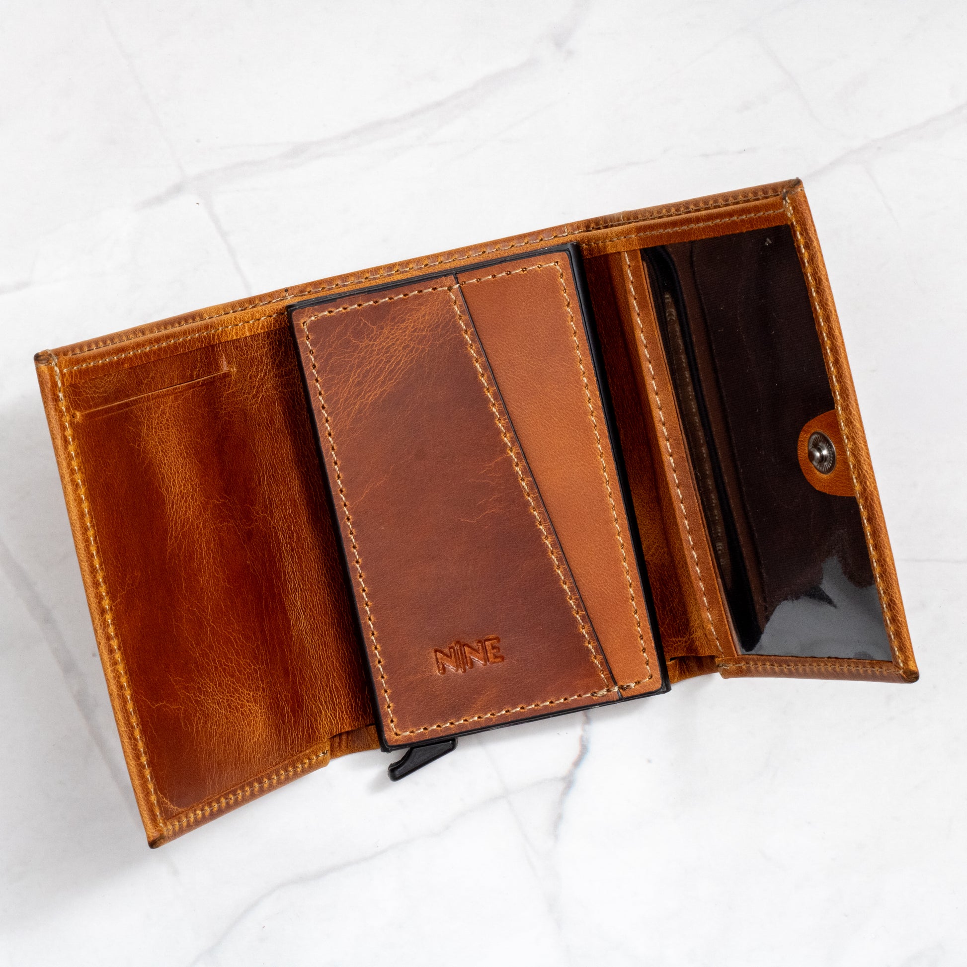 Full view of the open Tan Full-Grain Leather Pop-Up Trifold Wallet showing the central pop-up mechanism and multiple card slots.