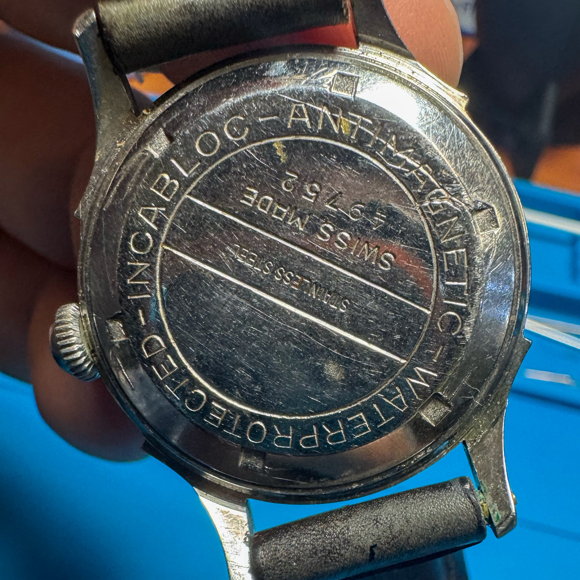 Exterior stainless steel case back of a vintage Minerva watch engraved with Waterprotected, Incabloc, Antimagnetic, and Swiss Made marks