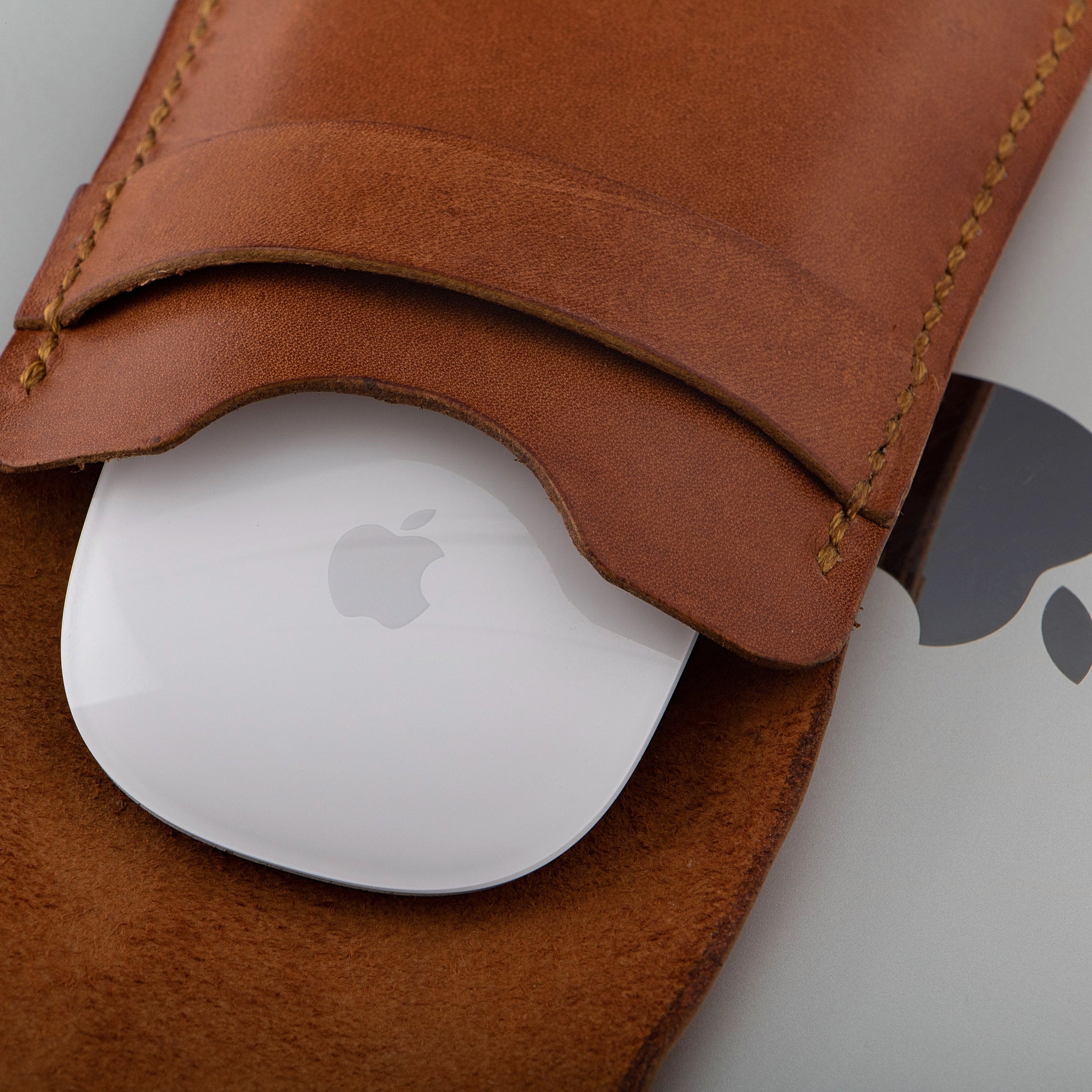 A close-up of the brown leather Magic Mouse case, highlighting its handcrafted details and premium materials.