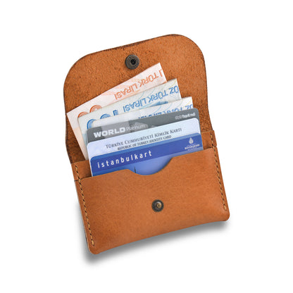 inside of a snap wallet in a white background cards and cash inside the wallet